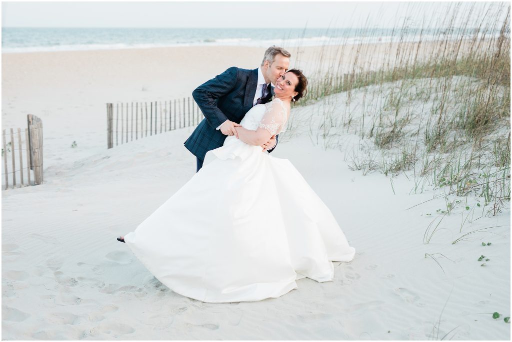 wedding photos on the beach, dip and kiss