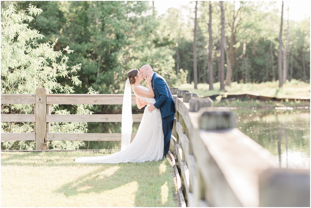 Kissing on fence at The Pavilion at Pepper Plantation Weddings
