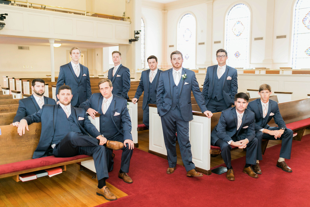 groomsmen pose in church