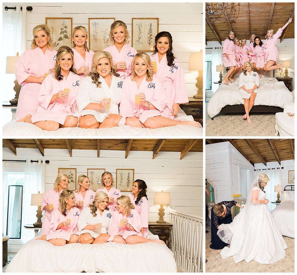 Bridesmaids posing on bed in robes