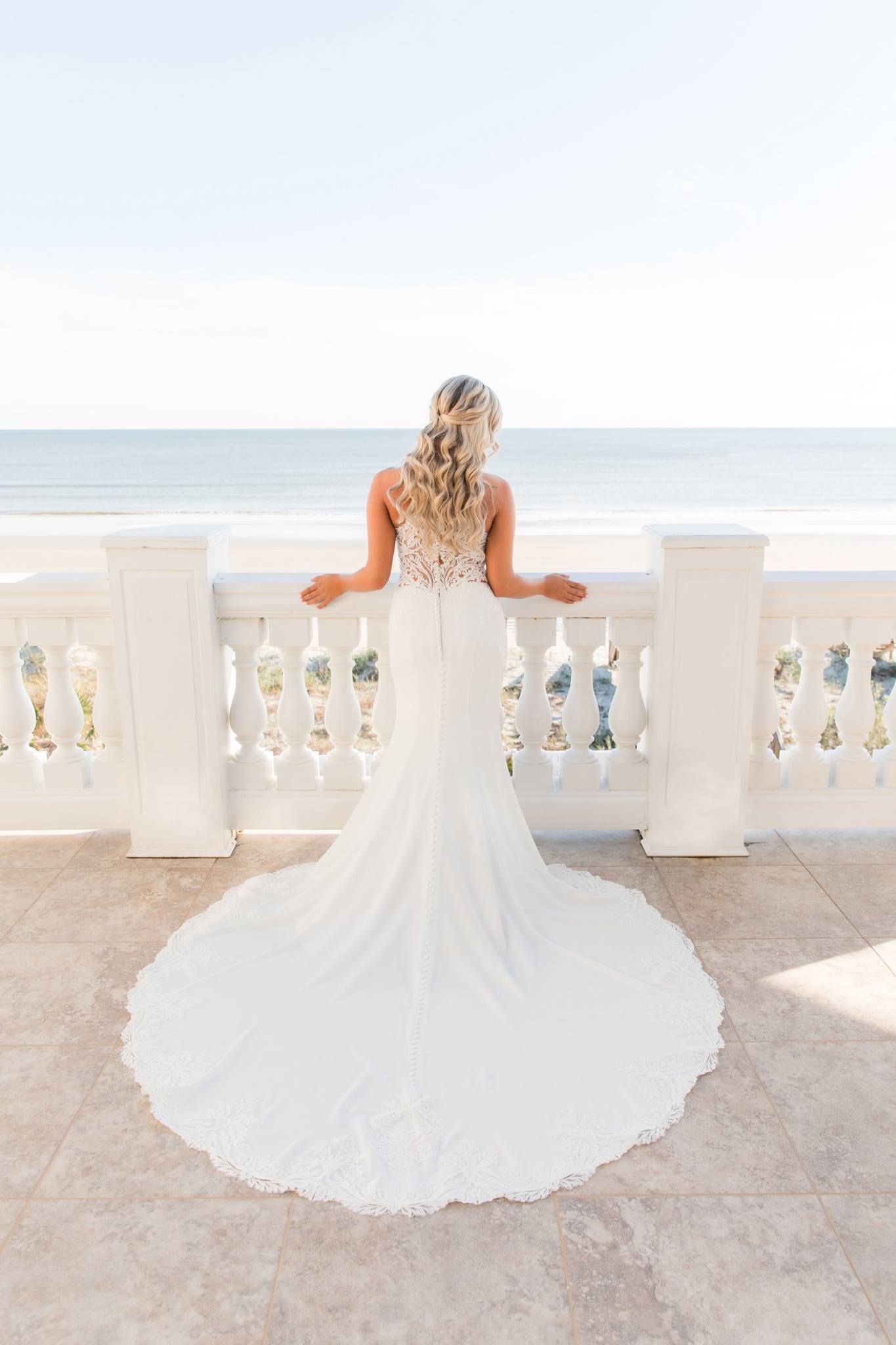 Bride on balcony Weddings Ocean Isle Beach