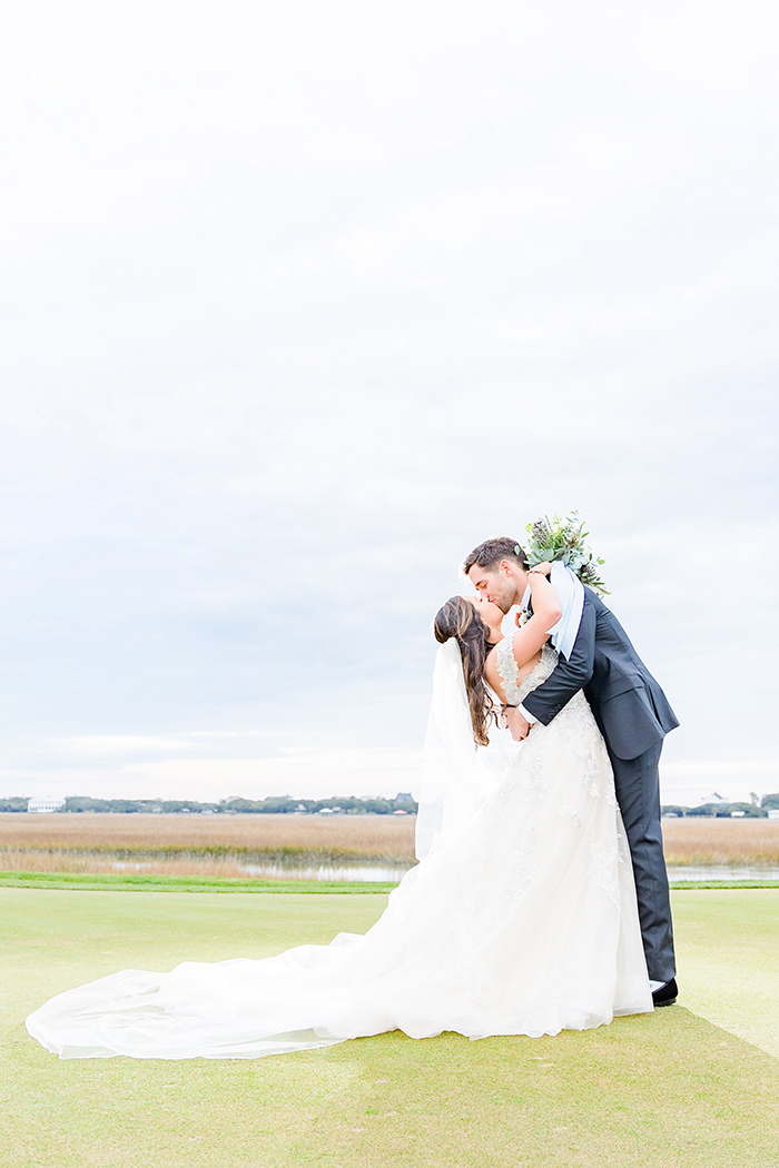 Bride and Groom kissing on Golf Course