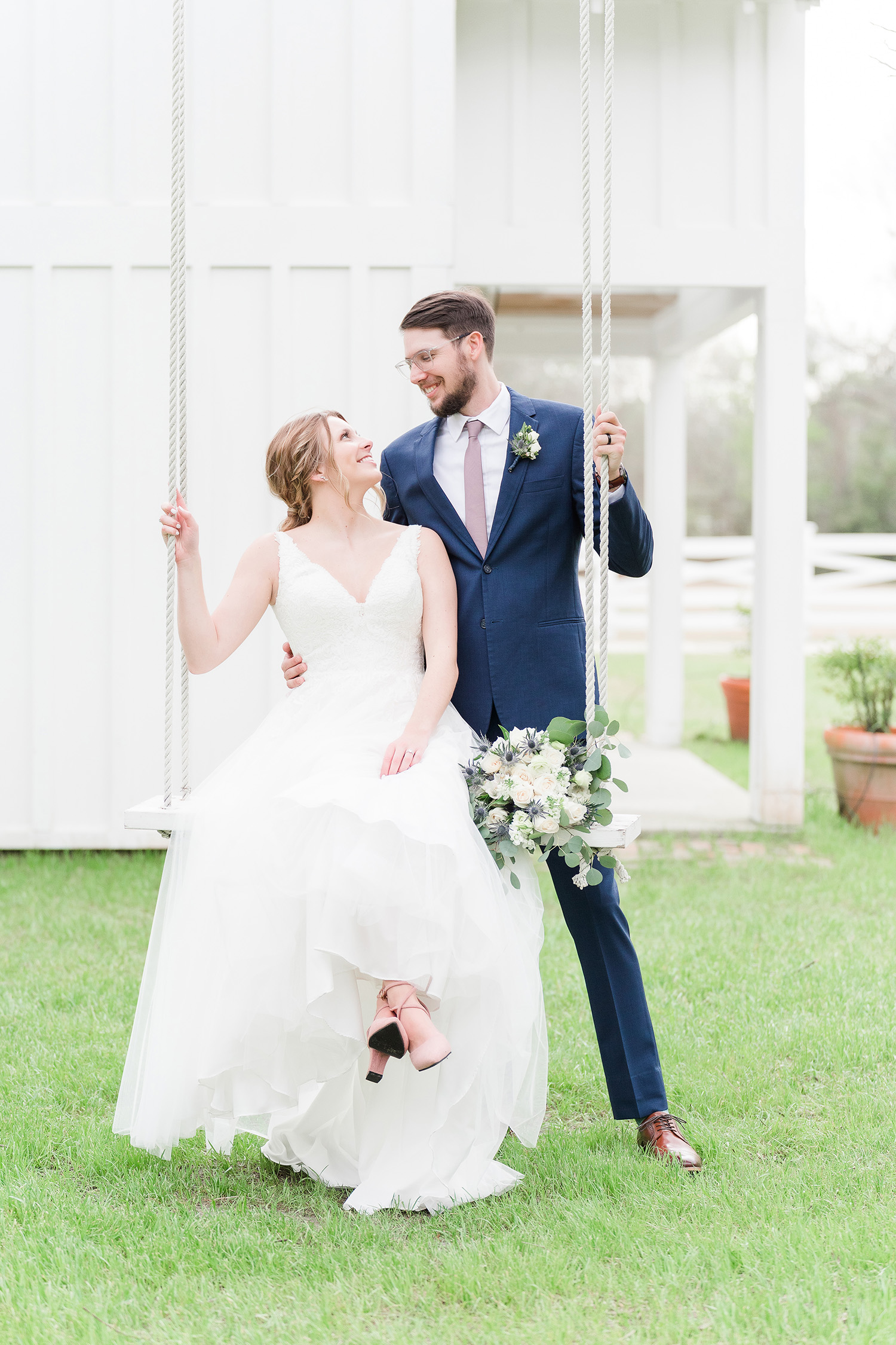 Bride and groom on swing wedding day