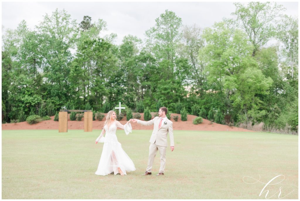 boho bride and groom twirl at The Blessed Barn, Aynor SC.
