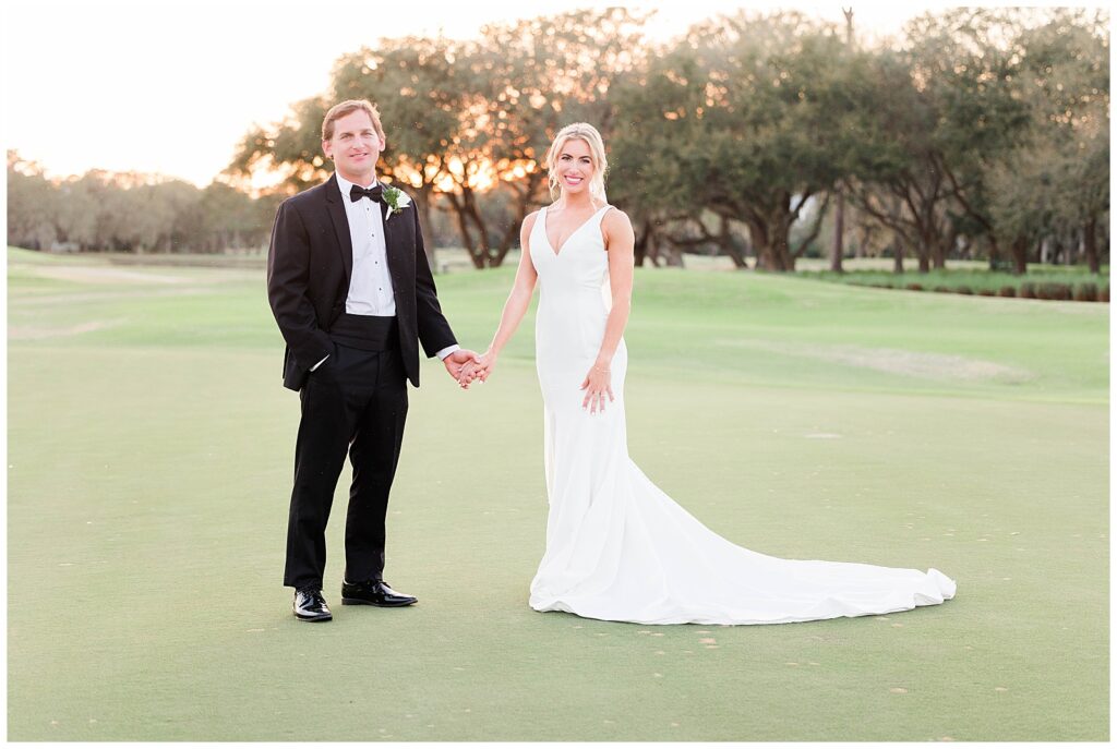 Bride and Groom under Live oak Trees and Moss on wedding day - Weddings at DeBordieu