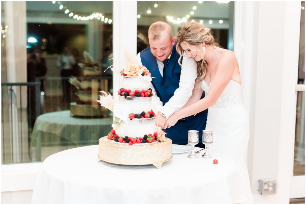 Bride and groom cutting Cake on wedding day