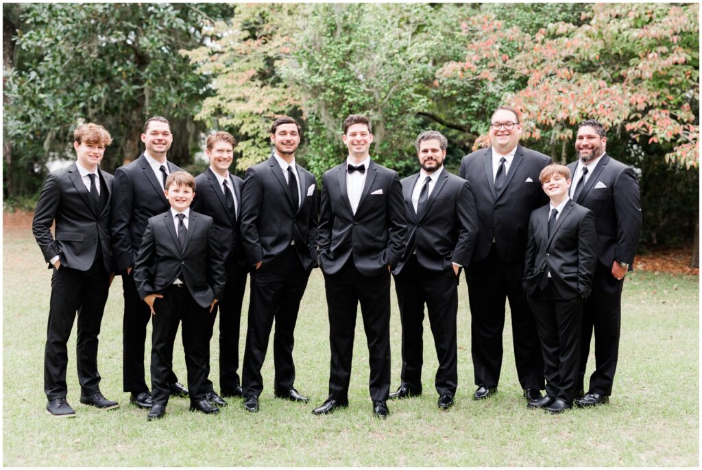 Groom and Groomsmen in black tux on wedding day pictures 