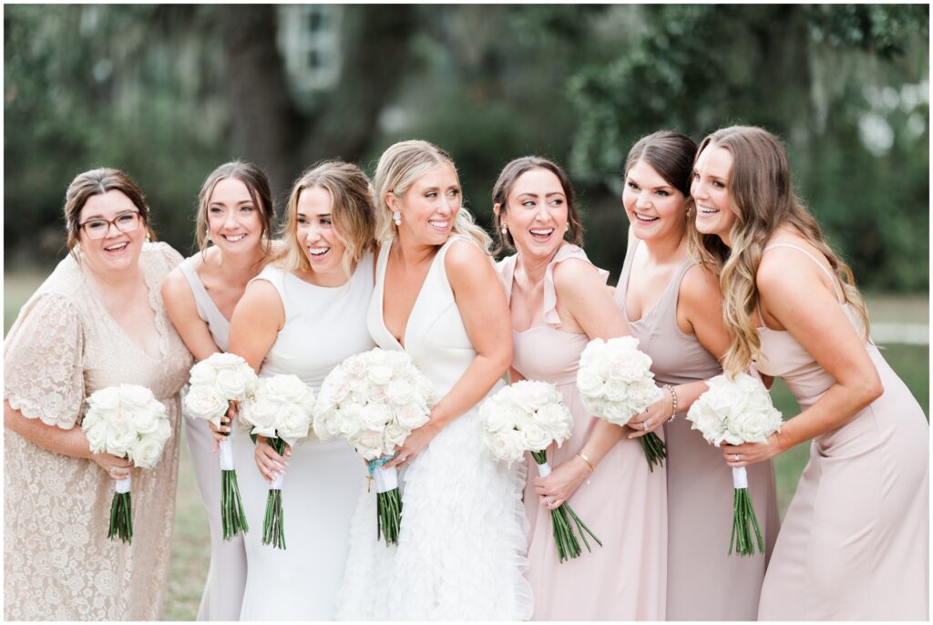bridal party laughing for posed photos on wedding day 