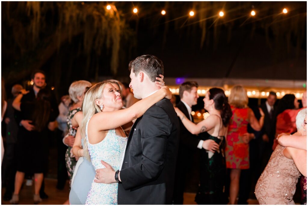 Bride and Groom Dancing under the twinkle Lights on their wedding day 