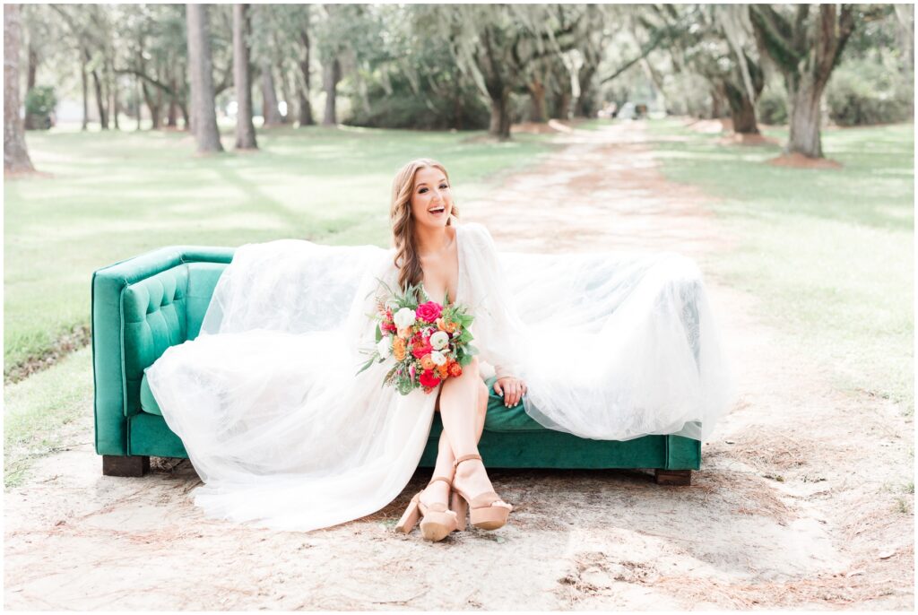 Bride on couch laughing in moss trees and history 