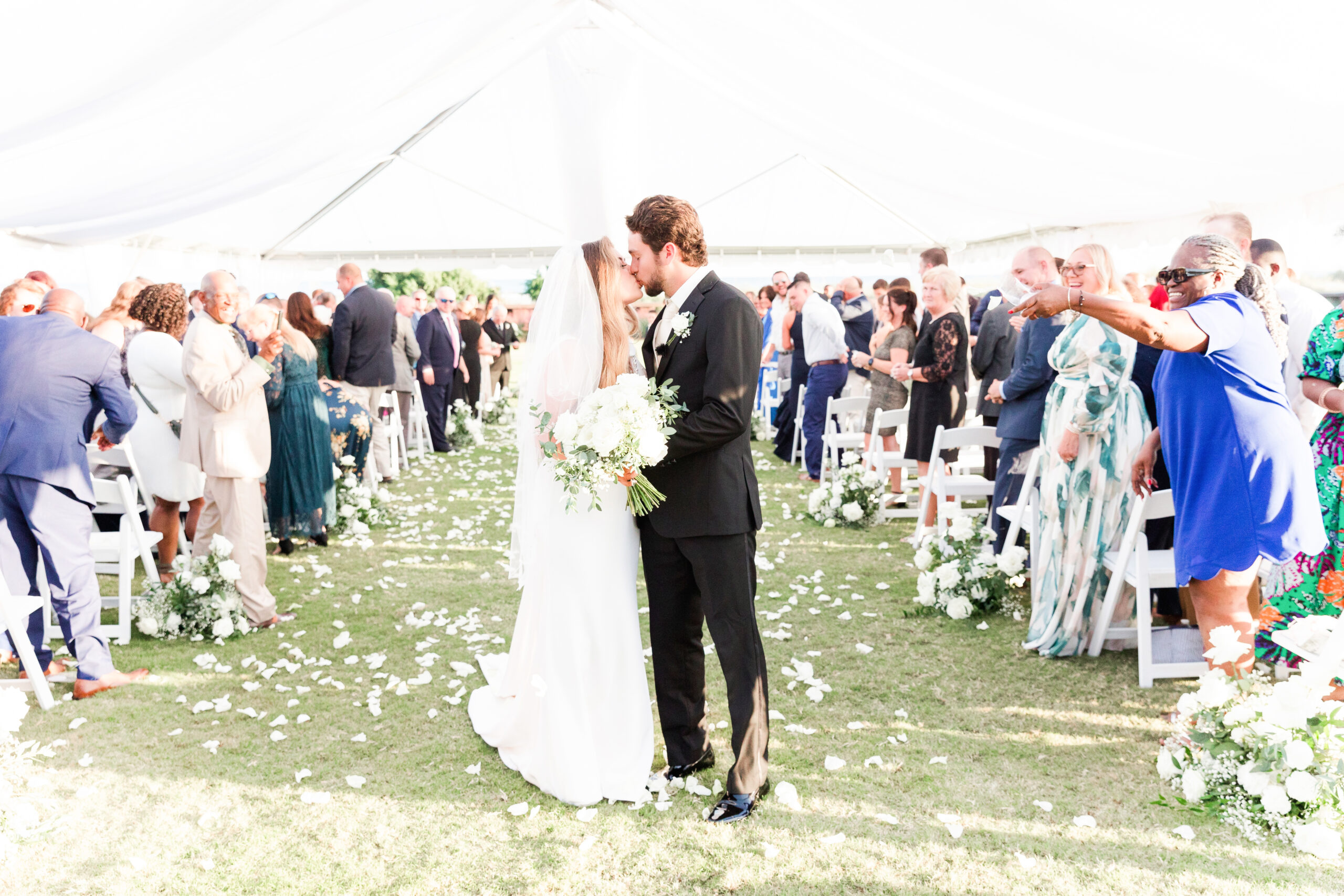 Bride and Groom kissing with Rose Pedals