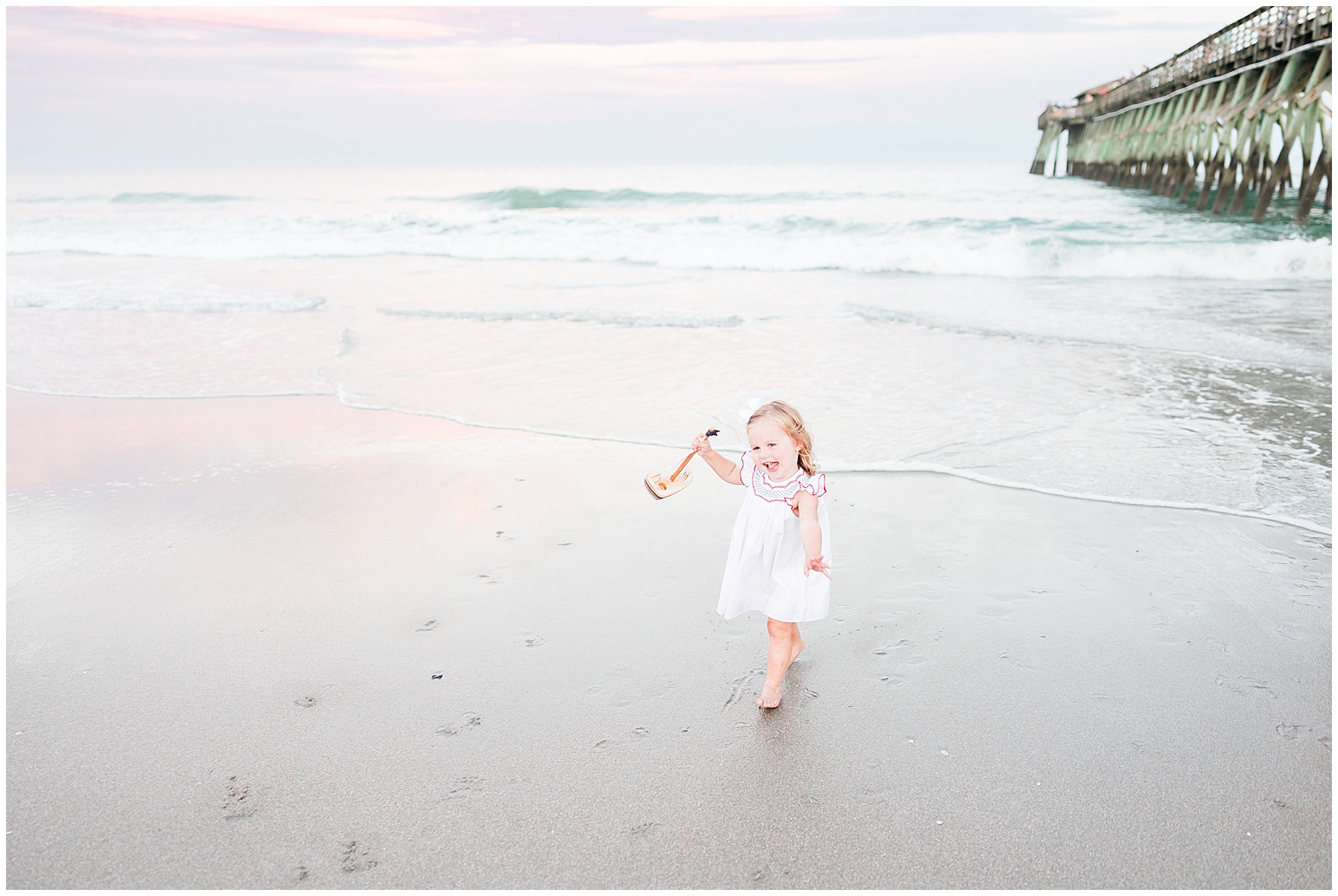Happy girl running on beach at sunset