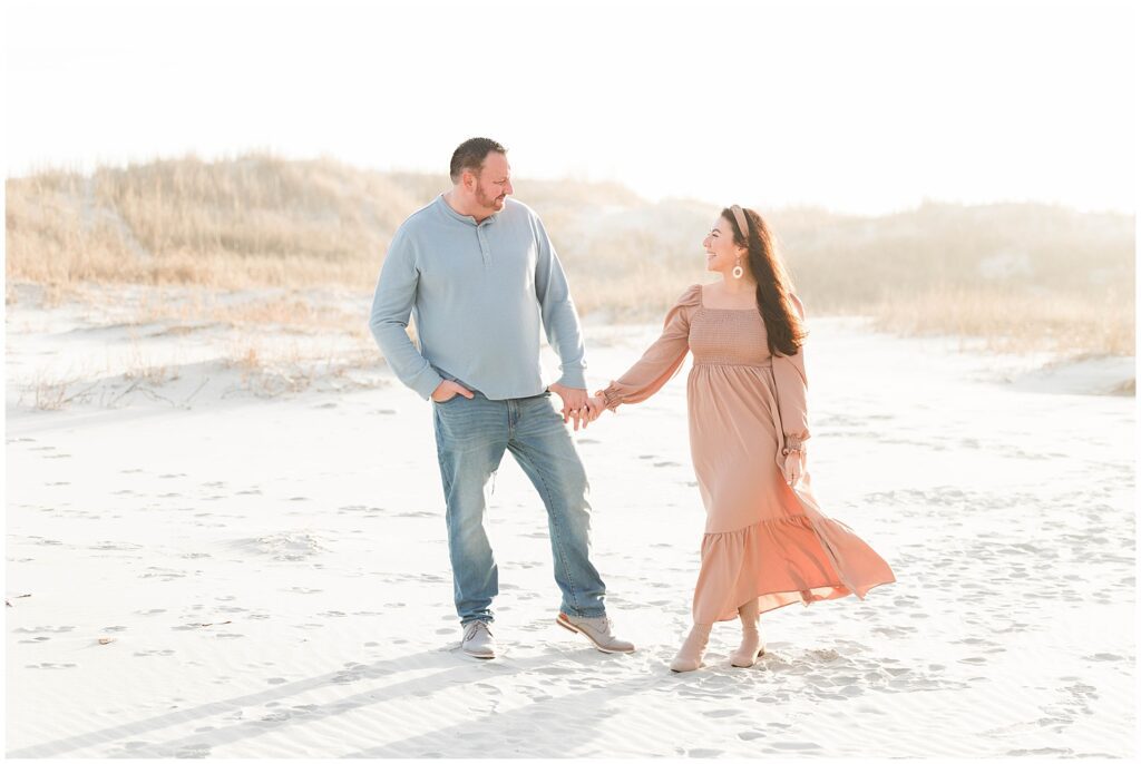 Wife and Husband posing in golden light on beach in myrtle beach.