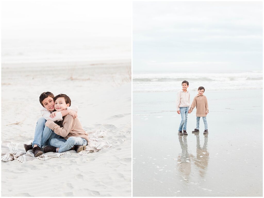 Boys on the beach posing for photos in colder weather.