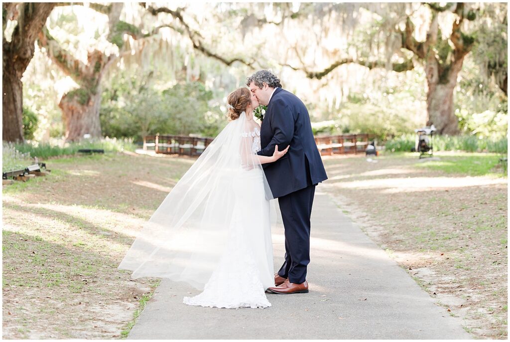 weddings at brookgreen gardens with bride and groom kissing. 