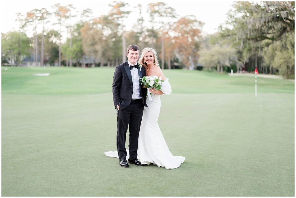 Bride and groom on golf course for photos