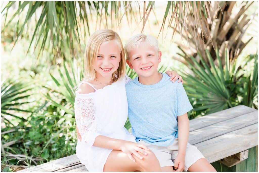 Boy and girl posing in pastel colors for photos. 