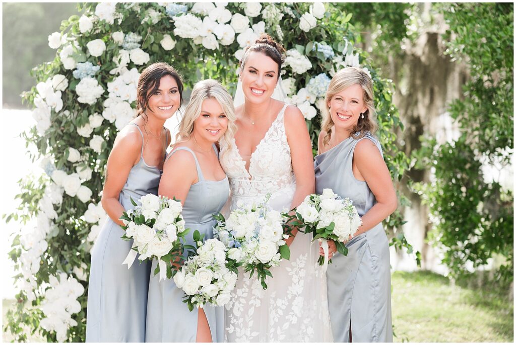 Beautiful ceremony arch at weddings on the lawn, Wachesaw Plantation weddings. Bridal party posing for photos after ceremony. 