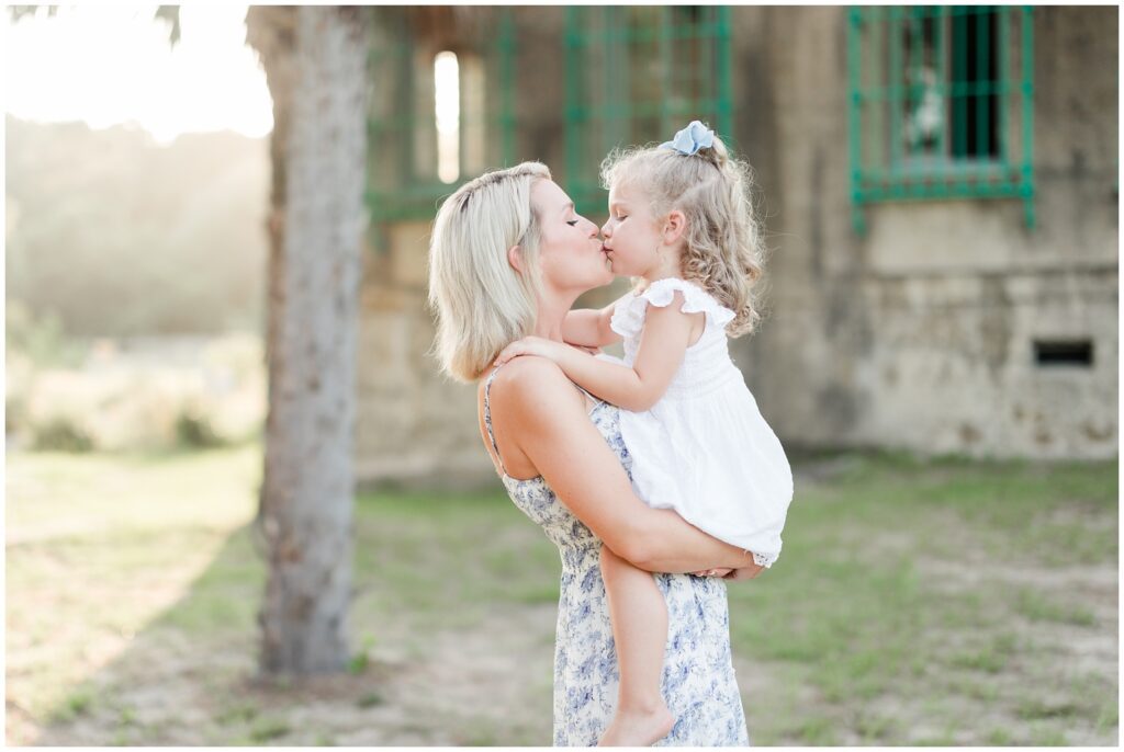 Daughter and Mom kissing for family photos in Myrtle Beach