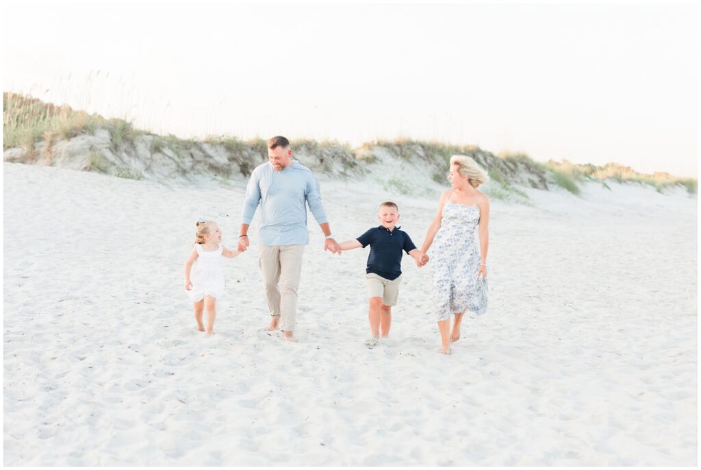 Family walking on the beach for photos at Huntington State Park, Pawleys Island, SC.