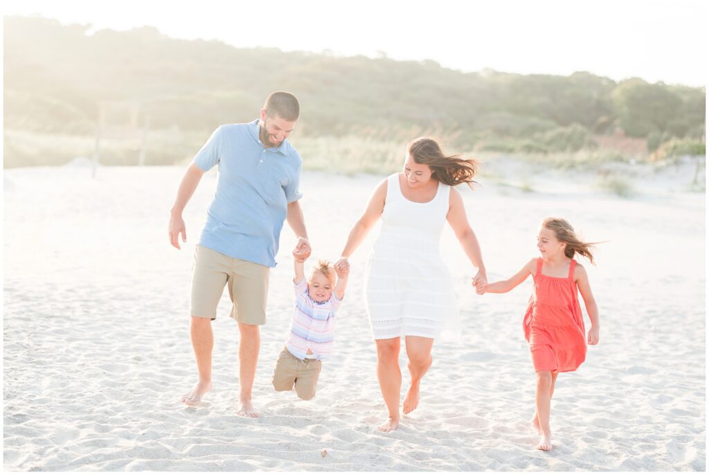 Family walking on the beach for photos