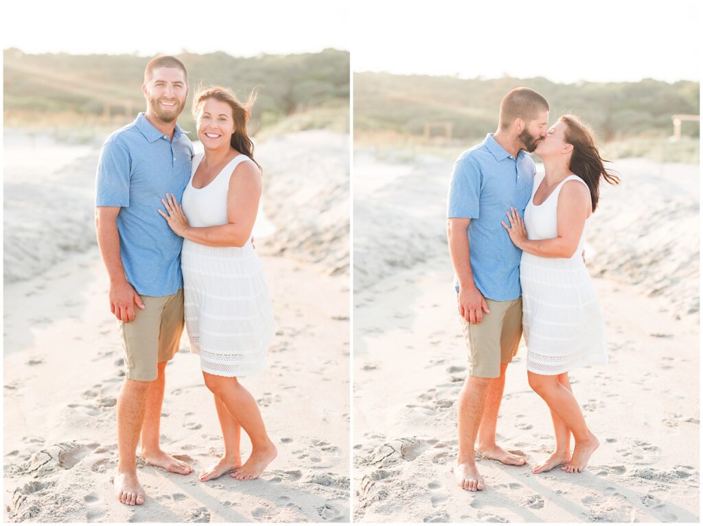 mom and dad kissing for photos on the beach during the wind