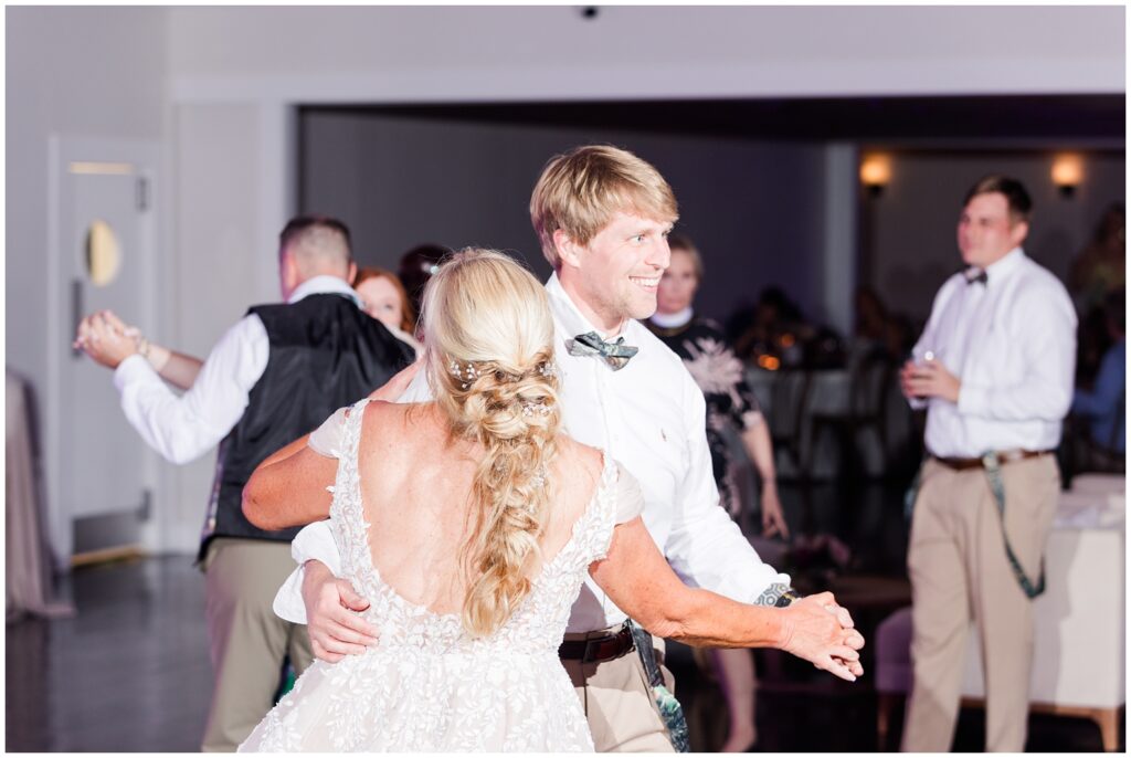 The bride dancing with her son on wedding day.