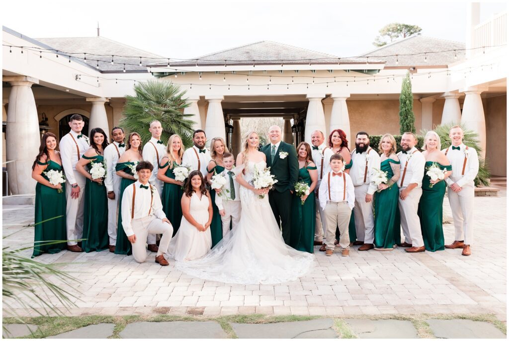 bridal party posing for photos in green ivory 