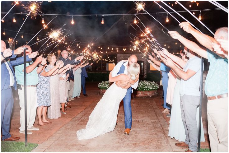 Sparkler exit on wedding day with bride and groom kissing 