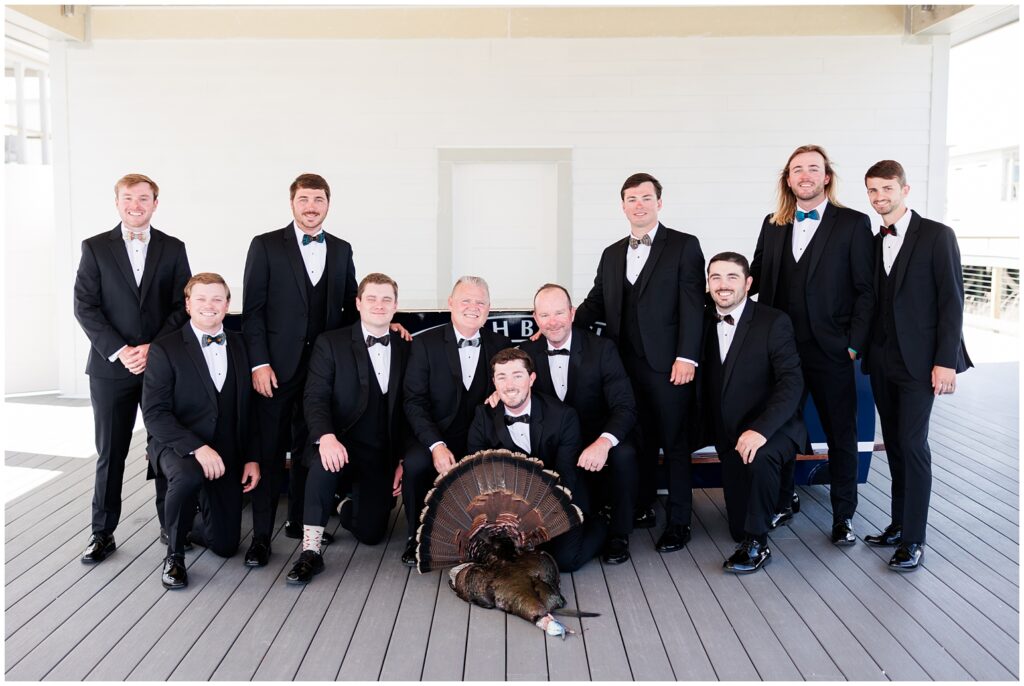 Groomsmen posing with turkey