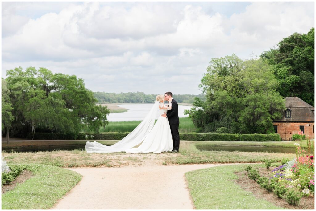 Bride and groom sharing emotional first look by the Butterfly Lakes at Middleton Place Charleston