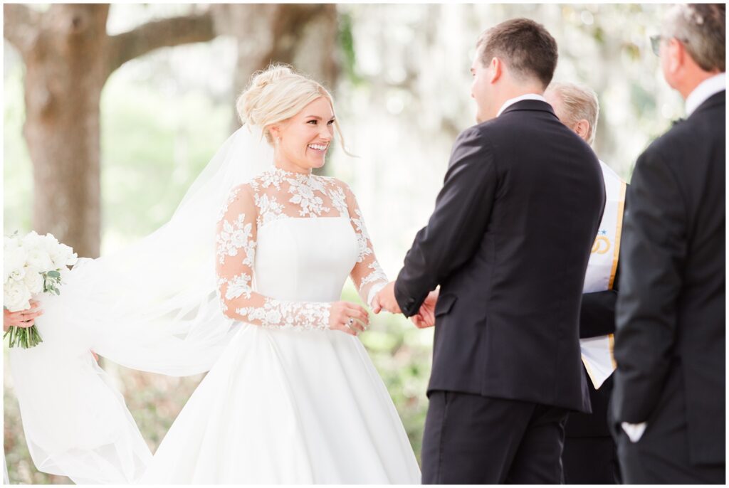 Elegant garden ceremony setup with white chairs and pastel florals at Middleton Place Charleston