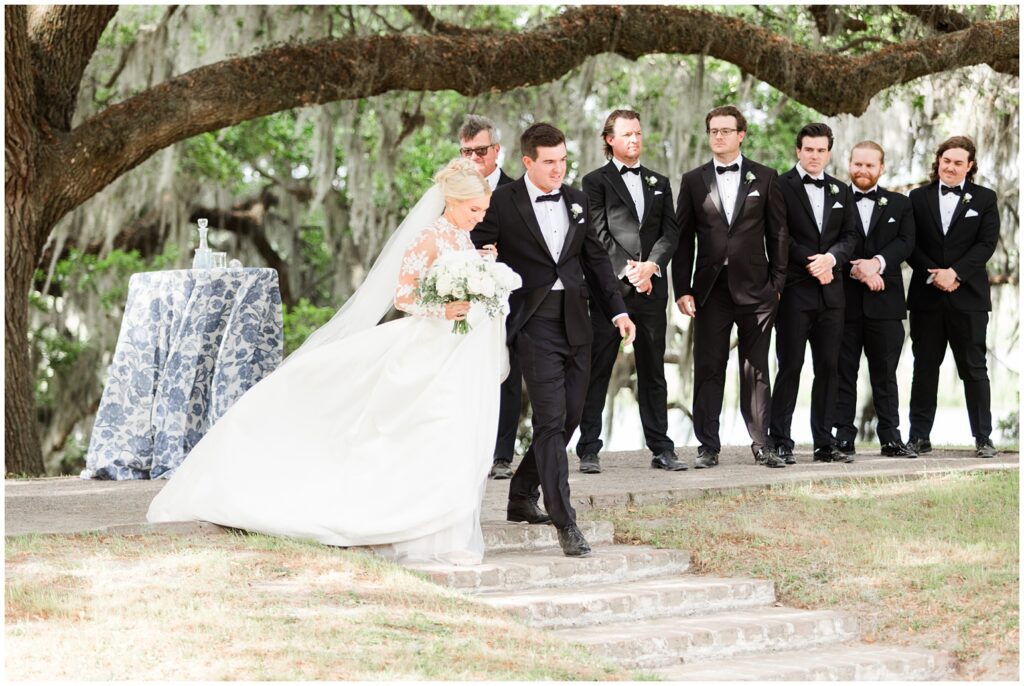 Elegant garden ceremony setup with white chairs and pastel florals at Middleton Place Charleston