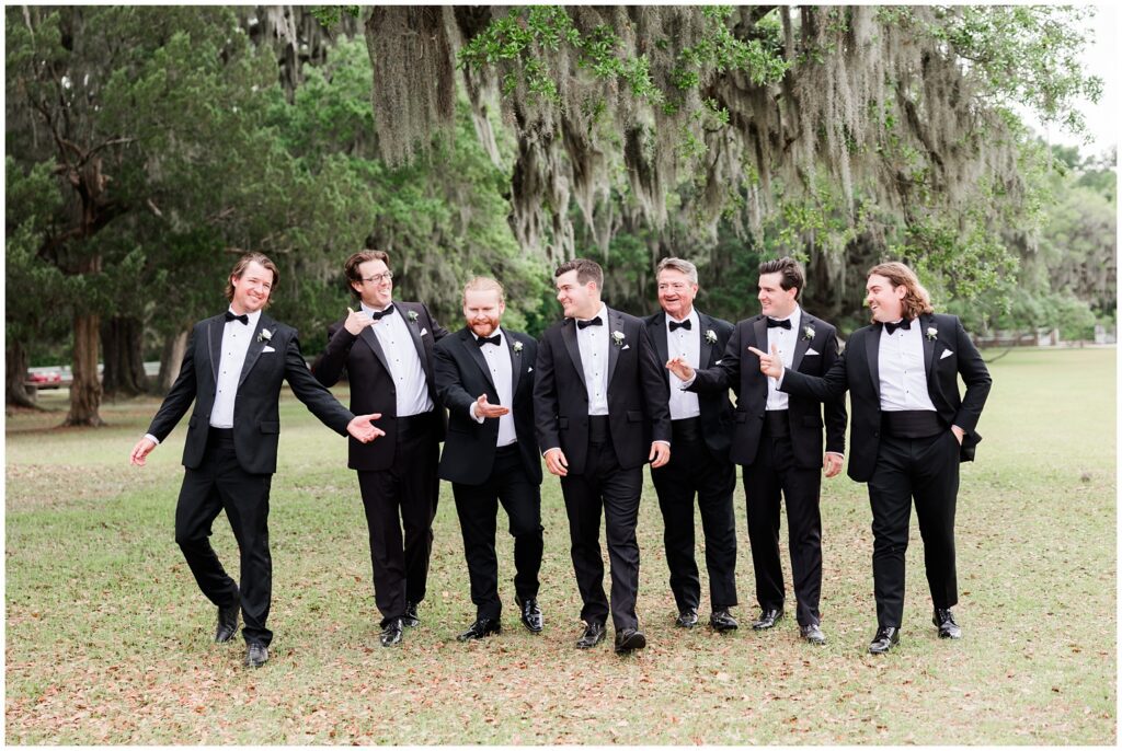  Bride and groom walking through blooming gardens at Middleton Place Charleston wedding venue