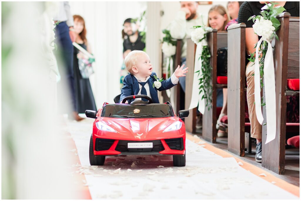 Ring bearer driving a mini Corvette down the aisle