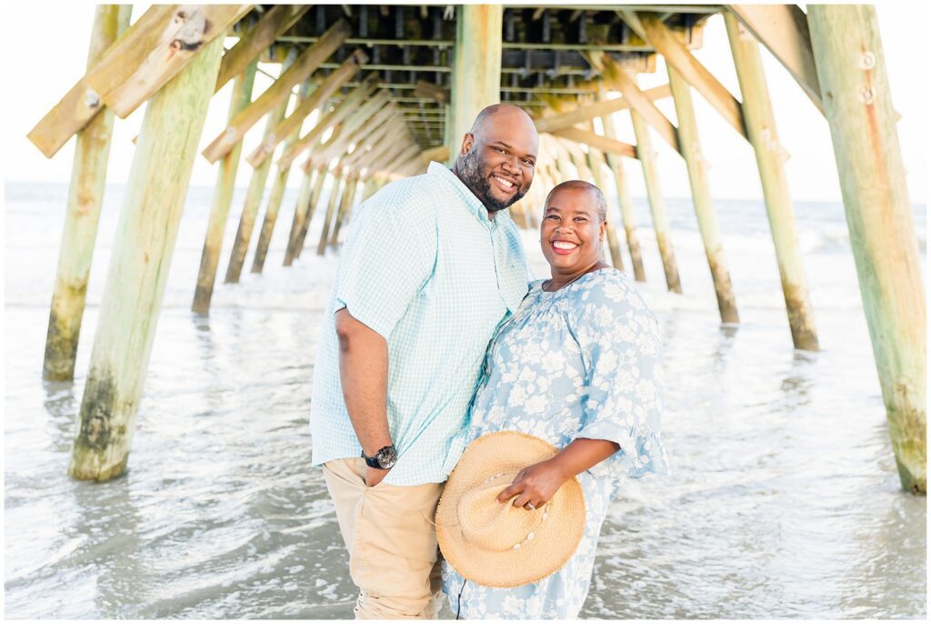 Family photography at Myrtle Beach State Park with pier in the background