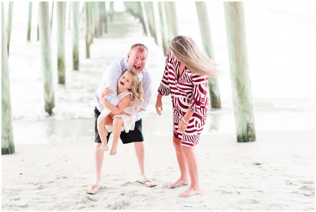 Photographer capturing portraits near Garden City Pier with coastal charm