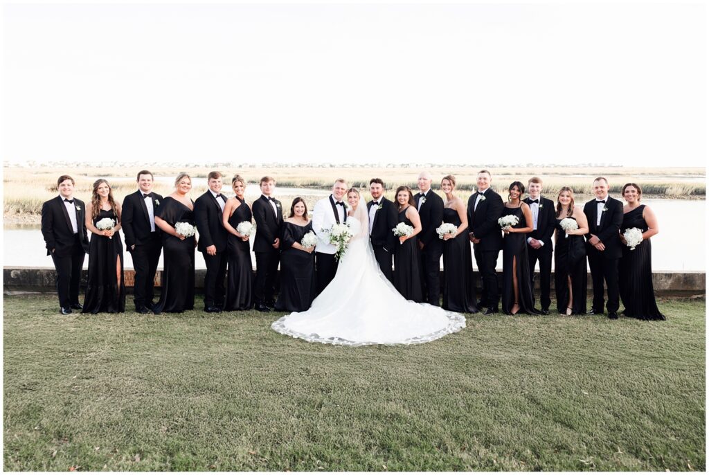 Bridal party of ten bridesmaids in black dresses at Pawleys Island wedding