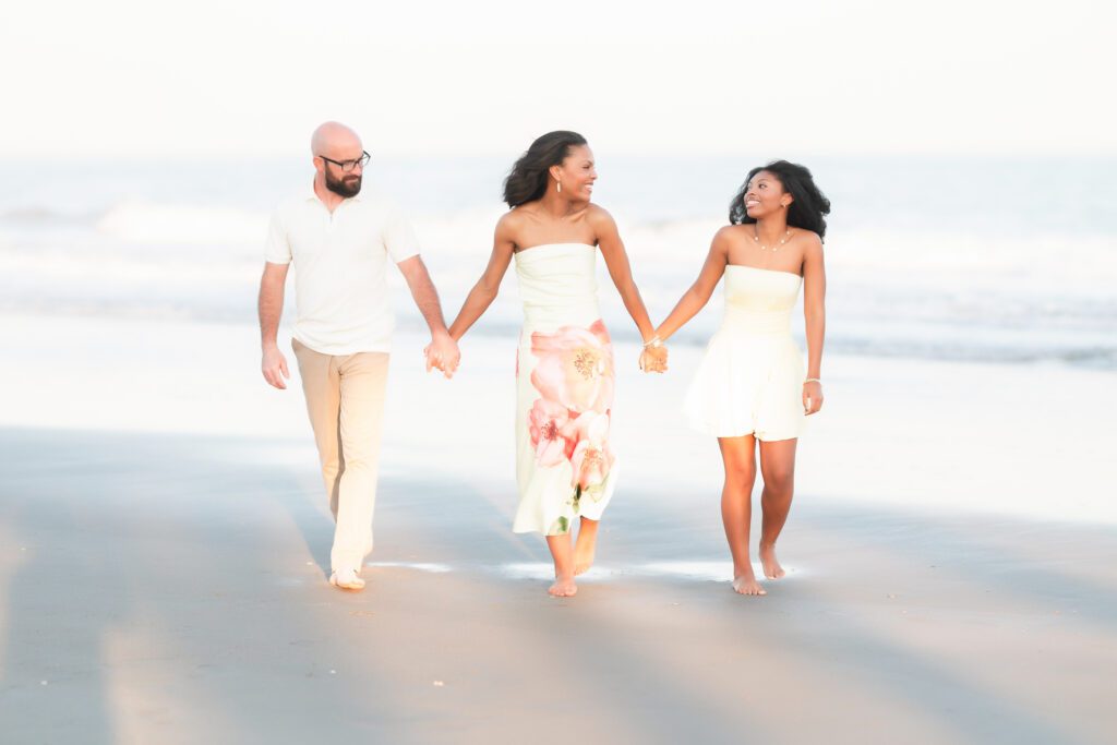 Low angle beach family portrait at Myrtle Beach State Park with wide open sky, light and airy photography