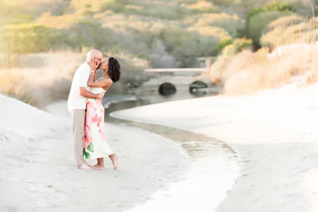 Mom and dad sharing a quiet moment together during family beach session at Myrtle Beach State Park
