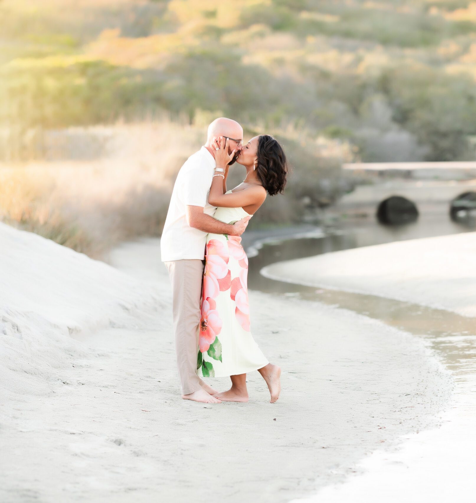Couple kissing on the beach for family photos