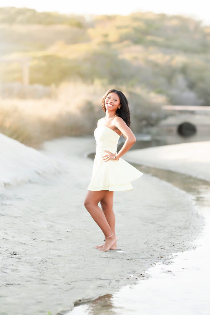 Beach Portraits in Myrtle Beach - young teen in yellow dress posing on the beach 