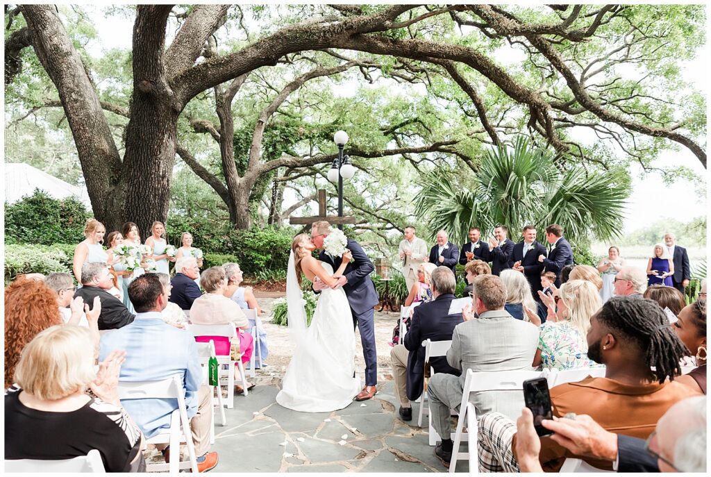 First kiss on wedding day, outside ceremony - A Kaminski House Wedding, Georgetown, SC.